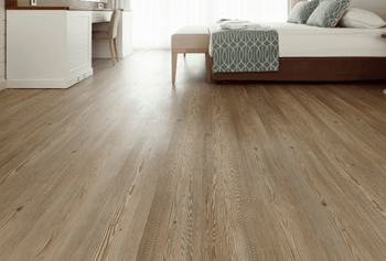 a bedroom with a bed and a wooden floor